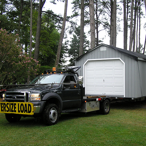 Shed being moved on a truck.